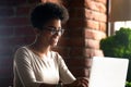 Happy African American woman using laptop, chatting with friends Royalty Free Stock Photo