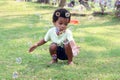 Happy smiling African boy blowing soap bubbles at green garden. Child having fun with bubble in summer park. Kid spending time Royalty Free Stock Photo