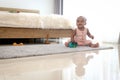 Happy smiling African cute toddle baby infant kid holding toy while crawling on floor in bedroom at home. Happy child with Royalty Free Stock Photo