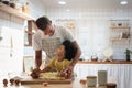 Happy Smiling African family  in Aprons Cooking and kneading dough on wooden table Royalty Free Stock Photo