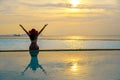Happy smiling asia woman with straw hat relax and luxury in swimming pool, background sunset.