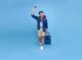 Happy smiling Asian bag packer man with passport and luggage enjoying their summer vacation getaway in blue background