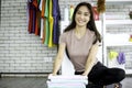 Happy smiling Asian beautiful young woman doing laundry at laundry room with washing machine, housewife doing housework and Royalty Free Stock Photo