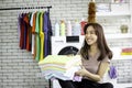 Happy smiling Asian beautiful young woman doing laundry at laundry room with washing machine, housewife doing housework and Royalty Free Stock Photo