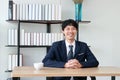 Happy smiling Asian business man laughing in office. Success celebration concept Royalty Free Stock Photo