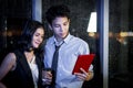 Happy smiling Asian business man and woman working together, look at digital tablet and have discussion, employee working hard Royalty Free Stock Photo