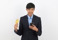 Happy smiling asian businessman in black suit using smartphone and holding credit card for online shopping, Internet banking Royalty Free Stock Photo
