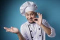 Happy Smiling Asian Chef Pointing Presenting Something on His Empty Hand Royalty Free Stock Photo