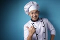 Happy Smiling Asian Chef Pointing Presenting Something on His Side Royalty Free Stock Photo