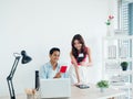 Happy smiling Asian couple, young man and woman holding passport and flight tickets after booking online. Royalty Free Stock Photo