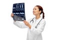 Happy smiling asian female doctor looking at x-ray Royalty Free Stock Photo