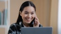 Happy smiling Asian girl Korean female freelancer chatting with friends on phone answering call friendly looking at Royalty Free Stock Photo