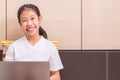 Happy smiling asian girl using notebook computer to study on her Royalty Free Stock Photo