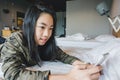 Happy smiling Asian kids on bed playing smart phone Royalty Free Stock Photo