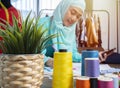 Happy smiling Asian muslim woman designer as a startup business owner working in her tailor shop Royalty Free Stock Photo