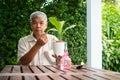 A happy and smiling Asian old elderly man is planting for a hobby after retirement in a home. Concept of a happy lifestyle and Royalty Free Stock Photo