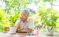A happy and smiling Asian old elderly man is planting for a hobby after retirement in a home. Concept of a happy lifestyle and Royalty Free Stock Photo