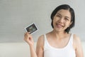 Happy Smiling Asian Pregnant woman with freckles holding showing ultrasound scan photo, Maternity prenatal care Royalty Free Stock Photo