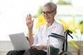 Happy smiling asian senior woman using laptop computer,old elderly making distance video call,greeting,say hi,wave her hand,talk Royalty Free Stock Photo