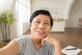 Happy smiling Asian senior woman using mobile phone taking selfie, Grandmother making video call on smatphone Royalty Free Stock Photo