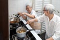 Happy smiling asian senior women are cooking stir-fried pork with basil and soup,elderly siblings enjoying preparing meal Thai Royalty Free Stock Photo