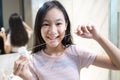 Happy smiling asian student girl flossing her teeth,clean her healthy teeth in the morning,beautiful woman brushing with dental Royalty Free Stock Photo