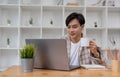 Happy smiling asian student using laptop computer. Online learning education concept. Royalty Free Stock Photo