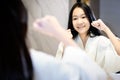 Happy smiling asian teenager girl flossing her teeth,clean her healthy teeth in front of a mirror,people brushing with dental Royalty Free Stock Photo