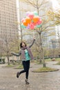 Happy smiling Asian woman holding balloons Royalty Free Stock Photo