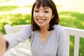 Happy smiling asian woman taking selfie at park Royalty Free Stock Photo