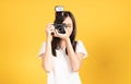 Happy smiling asian young girl photographer and looking viewfinder on retro digital mirrorless photo camera Royalty Free Stock Photo