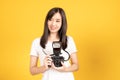 Happy smiling asian young girl photographer and looking viewfinder on retro digital mirrorless photo camera Royalty Free Stock Photo