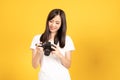 Happy smiling asian young girl photographer and looking viewfinder on retro digital mirrorless photo camera Royalty Free Stock Photo