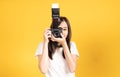 Happy smiling asian young girl photographer and looking viewfinder on retro digital mirrorless photo camera Royalty Free Stock Photo