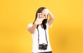 Happy smiling asian young girl photographer and standing with hands and finger making frame gesture Royalty Free Stock Photo