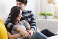 Happy & smiling attractive young cute Asian couple in love hugging and holding hands on bed in bedroom at home together. Happiness Royalty Free Stock Photo