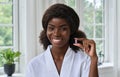 Young pretty happy smiling black girl holding beauty pill. Headshot portrait. Royalty Free Stock Photo