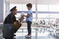 Happy smiling aviator presenting toy his child Royalty Free Stock Photo