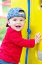 Happy smiling baby boy on playground in summertime