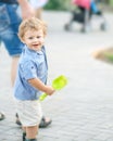 A happy smiling baby boy walking with young father at summer park. A family with a cute little son outside. Parental love, Father Royalty Free Stock Photo