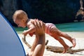 Happy smiling baby in dad arms. On a tropical beach. Sunny day, father throws up infant toddler, hold on hands. Child enjoy Royalty Free Stock Photo