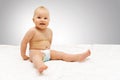 Happy smiling baby girl wearing diaper sitting on blanket Royalty Free Stock Photo