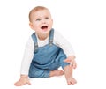 Happy smiling Baby in Jeans sitting over White isolated Background. Laughing little Child crawling looking up. Cheerful One Year Royalty Free Stock Photo