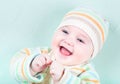 Happy smiling baby in a warm striped knitted sweat Royalty Free Stock Photo