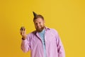 Happy, Smiling, Bearded Man Standing With Cake, Celebrating Birthday Against Yellow Studio Background