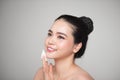 Happy smiling beautiful asian woman using cotton pad cleaning sk Royalty Free Stock Photo