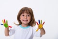 Happy smiling beautiful little girl with her colorful hands in the paint isolated on white background Royalty Free Stock Photo