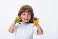 Happy smiling beautiful little girl with her colorful hands in the paint isolated on white background Royalty Free Stock Photo