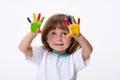 Happy smiling beautiful little girl with her colorful hands in the paint isolated on white background Royalty Free Stock Photo