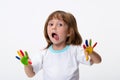 Happy smiling beautiful little girl with her colorful hands in the paint isolated on white background Royalty Free Stock Photo